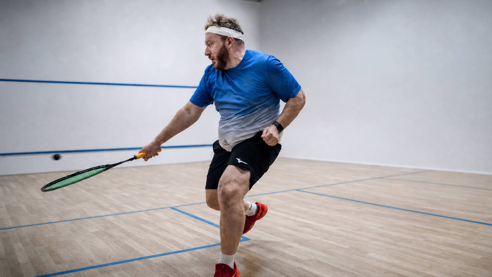 Mikhail Bakhman changing direction at speed during a squash competition